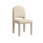 تحميل الصورة إلى عارض المعرض، The Shelly fabric dining chair in a neutral grey setting, emphasizing its refined and modern aesthetic.