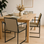 تحميل الصورة إلى عارض المعرض، The Joelle dining chair styled in a modern setup, emphasizing its sleek iron leg design.