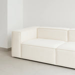 تحميل الصورة إلى عارض المعرض، White modular couch in a bright open-concept living room, offering both style and comfort.