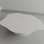 تحميل الصورة إلى عارض المعرض، The Jamie Coffee Table shown on a grey backdrop, featuring a polished micro plaster finish and round glass surface – a standout modern glass coffee table UAE shoppers will appreciate.