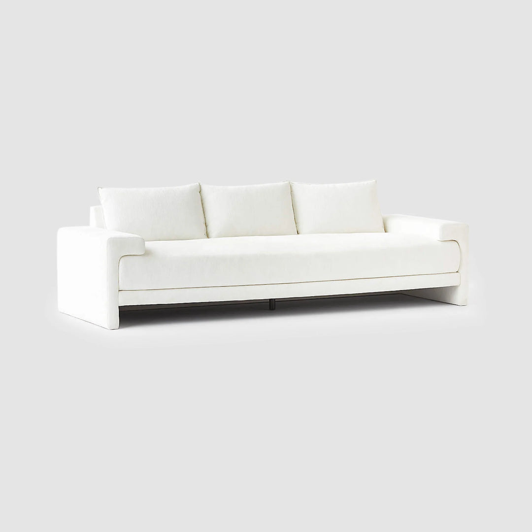 The Sylvia modern white sofa with seamless texture, highlighted on a grey backdrop for contrast.