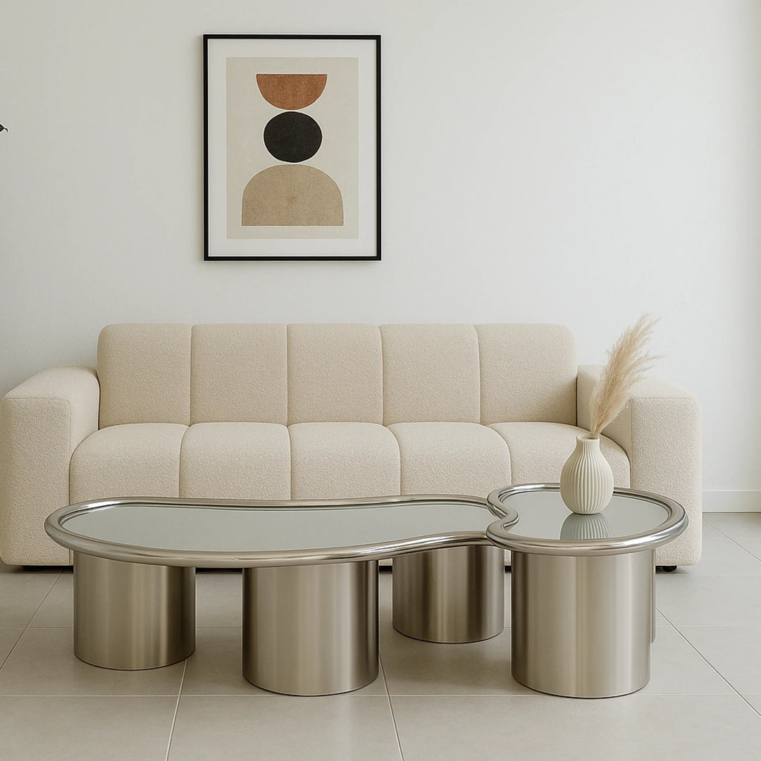 In a stylish living room setting, The Willow Chrome Coffee Table With Small Gestures serves as a functional and aesthetic centerpiece