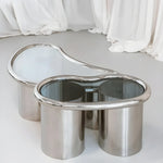 تحميل الصورة إلى عارض المعرض، Close-up of The Willow Chrome Coffee Table With Small Gestures showcases its polished chrome legs and clear glass top.