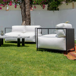 تحميل الصورة إلى عارض المعرض، Two-seater outdoor sofa from The Dexter collection placed by a poolside with vibrant decor.