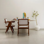 تحميل الصورة إلى عارض المعرض، Round dining table with a microplaster finish, paired with chic chairs in a vibrant dining space.