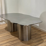 تحميل الصورة إلى عارض المعرض، Stylish steel dining table with a reflective stainless steel top, placed in a spacious and chic dining area.
